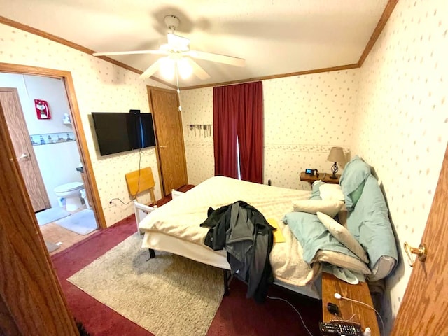 carpeted bedroom with ornamental molding, connected bathroom, and ceiling fan