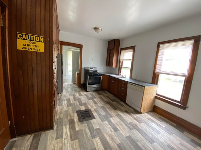 kitchen with hardwood / wood-style floors, stainless steel appliances, and sink