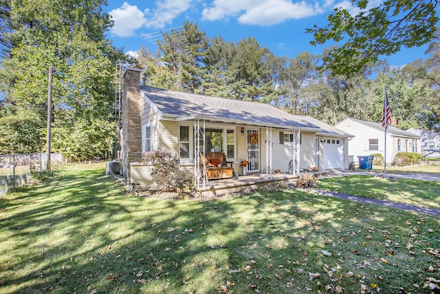 view of front of house with a front lawn, central AC, covered porch, and a garage