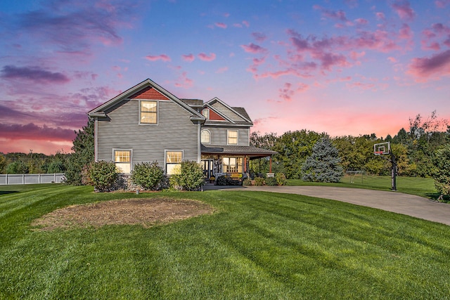 view of front property featuring a porch and a yard