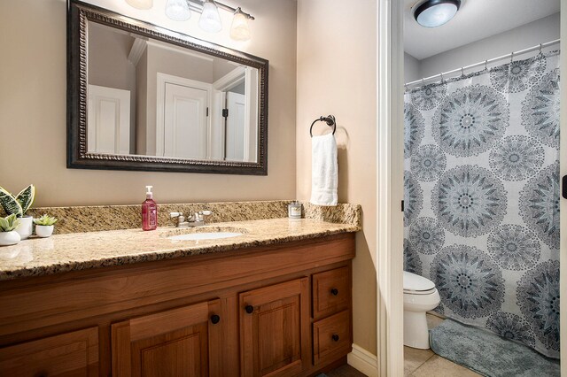 bathroom featuring vanity, toilet, and tile patterned floors