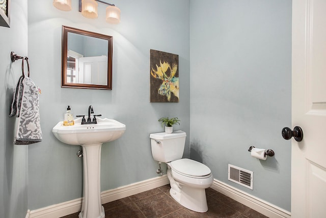 bathroom with toilet and tile patterned floors