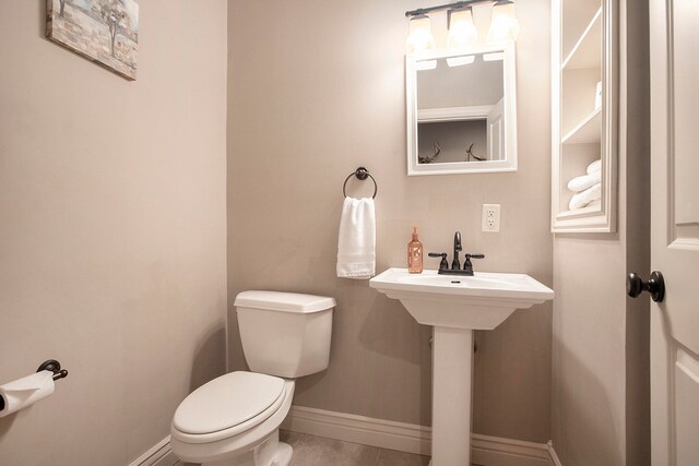 bathroom with tile patterned flooring and toilet