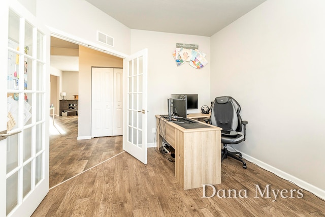 office space with french doors and hardwood / wood-style flooring