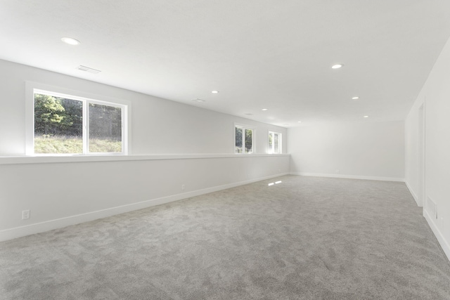 unfurnished room with plenty of natural light and carpet