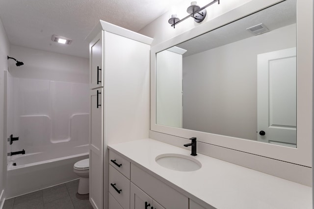 full bathroom featuring vanity, tile patterned flooring, a textured ceiling, bathing tub / shower combination, and toilet