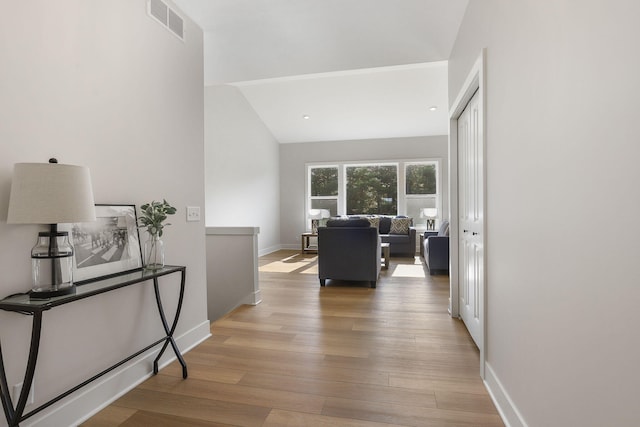 9530 Shoreway Dr, West Olive, MI 49460 - corridor with light wood-type flooring, baseboards, and vaulted ceiling