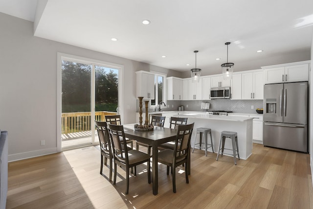 9530 Shoreway Dr, West Olive, MI 49460 - dining area with recessed lighting, light wood-style flooring, and baseboards