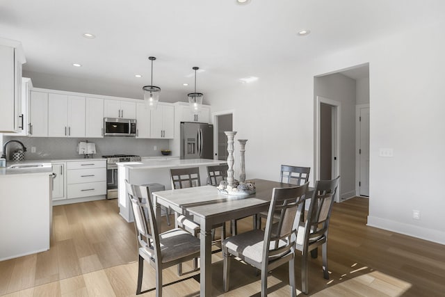 9530 Shoreway Dr, West Olive, MI 49460 - dining area featuring recessed lighting, light wood finished floors, and baseboards