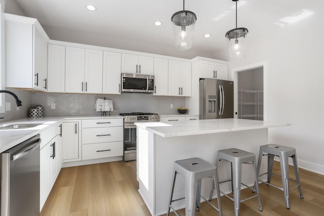 9530 Shoreway Dr, West Olive, MI 49460 - kitchen with stainless steel appliances, a sink, light wood-type flooring, tasteful backsplash, and recessed lighting