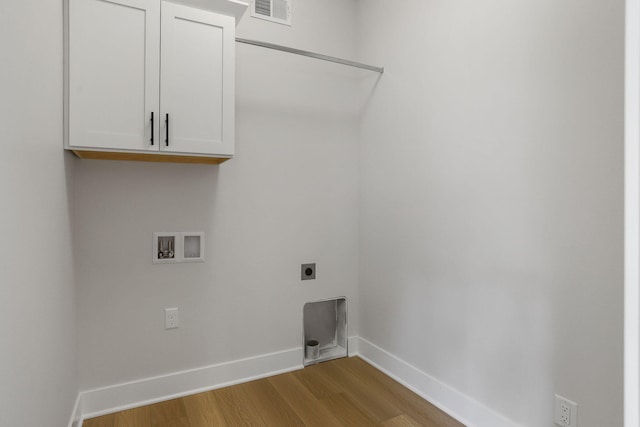 9530 Shoreway Dr, West Olive, MI 49460 - washroom with cabinet space, wood finished floors, hookup for a washing machine, baseboards, and electric dryer hookup