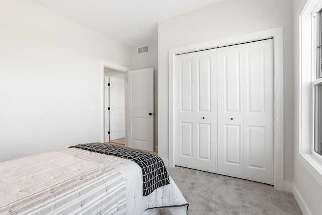 9530 Shoreway Dr, West Olive, MI 49460 - bedroom featuring light colored carpet, a closet, and baseboards