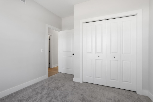 9530 Shoreway Dr, West Olive, MI 49460 - unfurnished bedroom featuring carpet, a closet, and baseboards