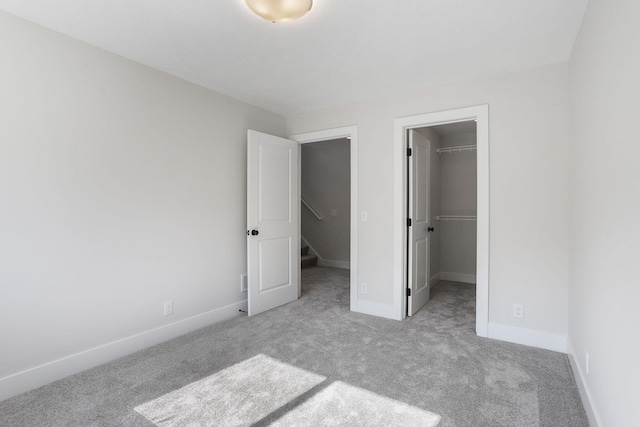 9530 Shoreway Dr, West Olive, MI 49460 - unfurnished bedroom featuring carpet floors, a walk in closet, baseboards, and a closet