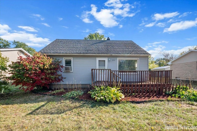 rear view of property featuring a deck and a lawn