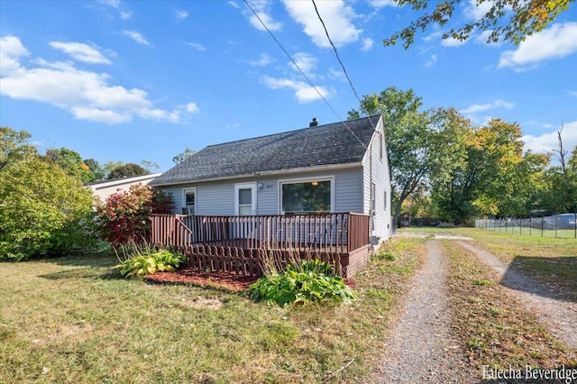 view of front of property with a front yard and a deck