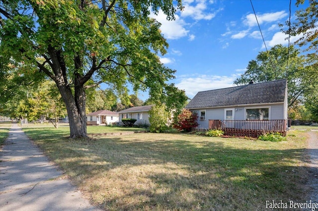 ranch-style home with a front yard and a deck