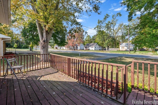 wooden terrace featuring a yard