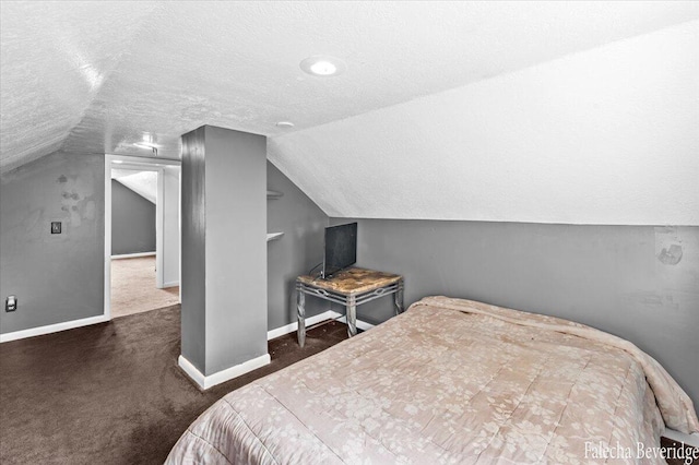 carpeted bedroom featuring vaulted ceiling and a textured ceiling