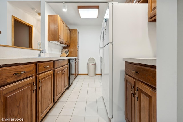 kitchen with dishwasher, rail lighting, light tile patterned floors, and white refrigerator