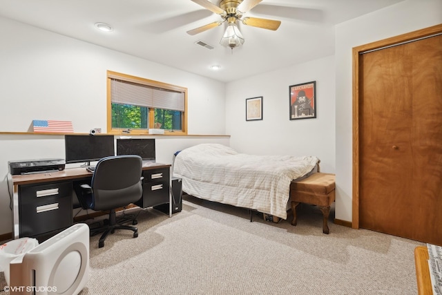 bedroom with ceiling fan and light carpet