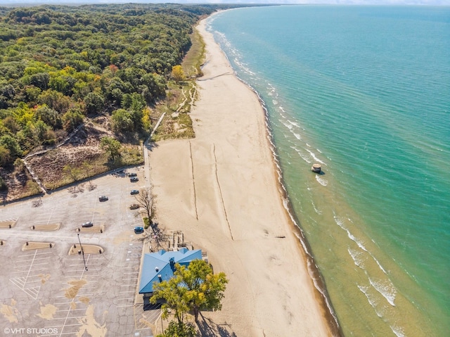 aerial view with a water view and a beach view