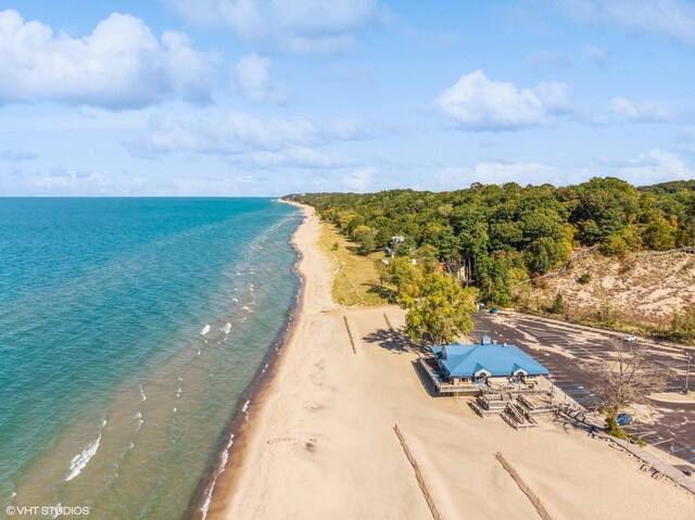 bird's eye view with a water view and a beach view