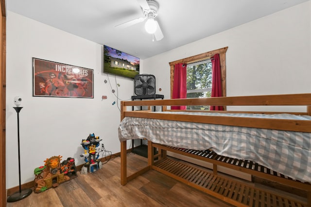 bedroom with ceiling fan and hardwood / wood-style flooring