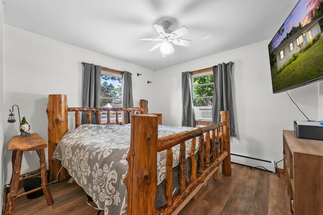 bedroom with a baseboard heating unit, dark hardwood / wood-style flooring, and ceiling fan