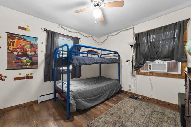 bedroom with ceiling fan, cooling unit, dark hardwood / wood-style flooring, and a baseboard heating unit