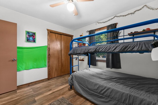 bedroom featuring a closet, hardwood / wood-style floors, and ceiling fan