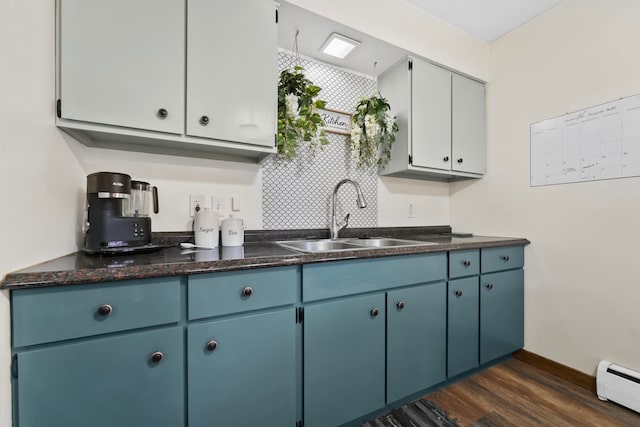 kitchen featuring blue cabinetry, sink, dark hardwood / wood-style flooring, and a baseboard radiator