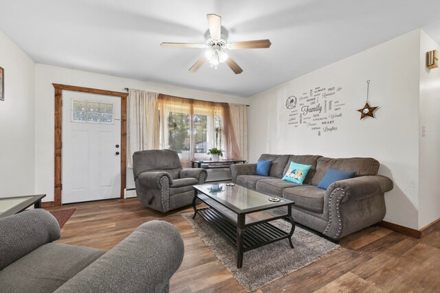 living room featuring ceiling fan, baseboard heating, and dark hardwood / wood-style flooring