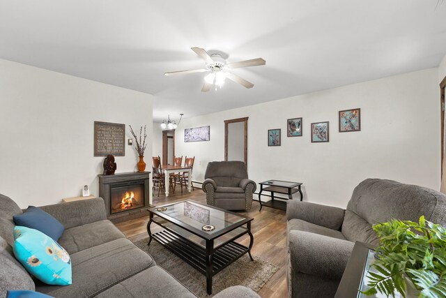 living room featuring wood-type flooring and ceiling fan