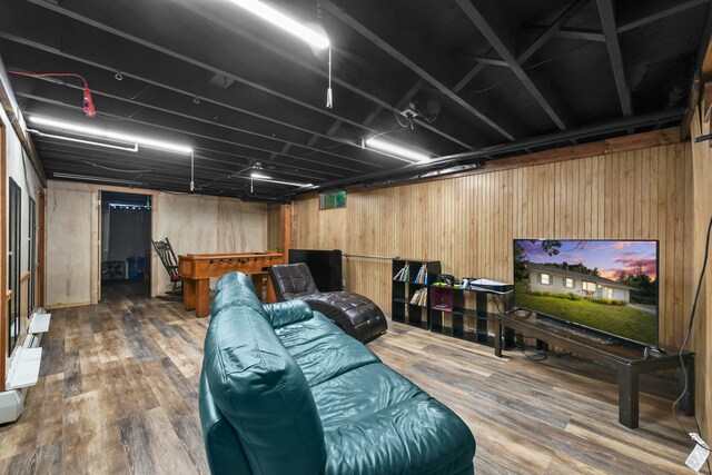 interior space with hardwood / wood-style flooring and wood walls