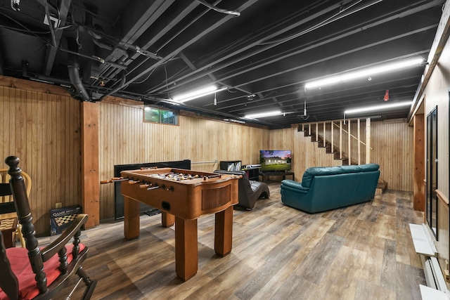 rec room featuring wooden walls and wood-type flooring