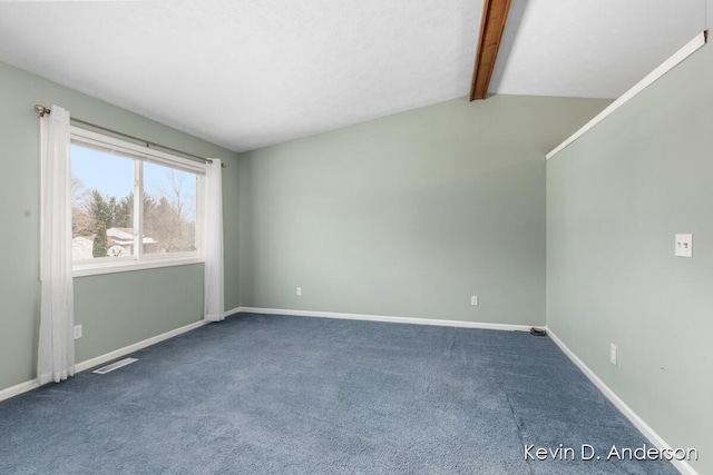 empty room with lofted ceiling with beams and carpet