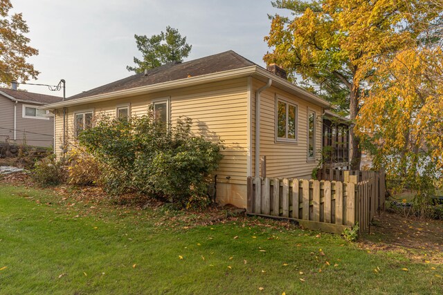 view of side of property with a yard