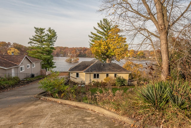 exterior space featuring a water view and central air condition unit