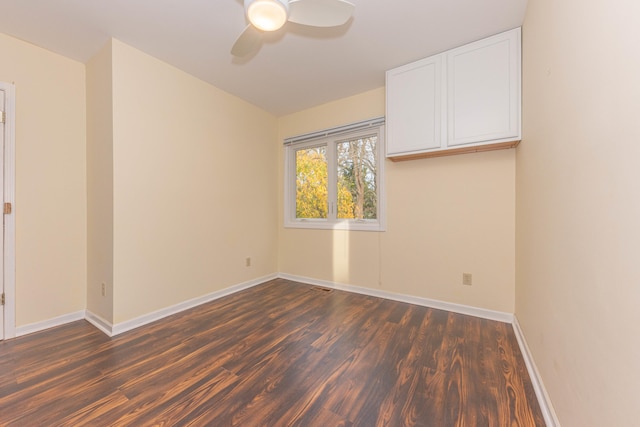 unfurnished room with ceiling fan and dark hardwood / wood-style flooring