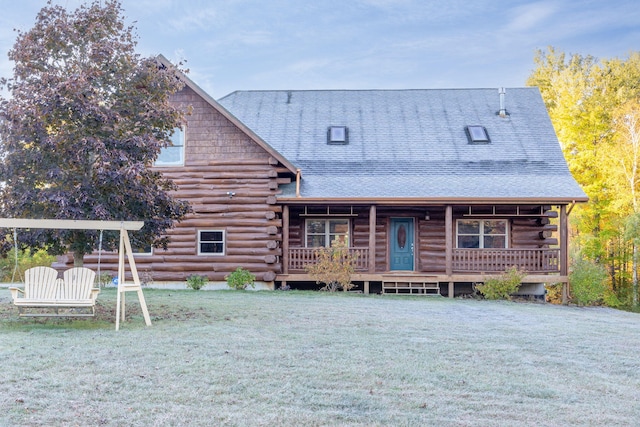 cabin with a porch and a front yard