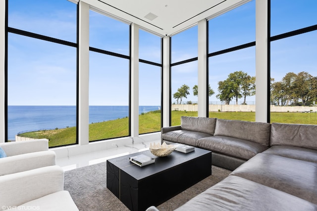 sunroom featuring a water view