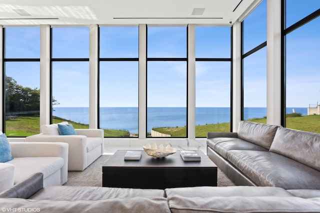 sunroom with plenty of natural light and a water view