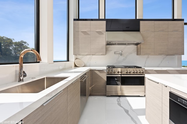 kitchen featuring backsplash, exhaust hood, sink, and stainless steel stove