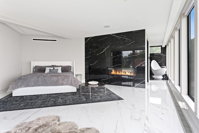 bedroom with a premium fireplace and multiple windows