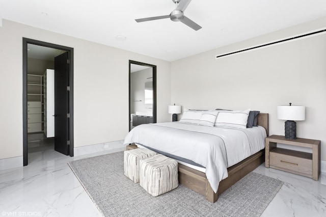 bedroom with ensuite bath, ceiling fan, and a walk in closet