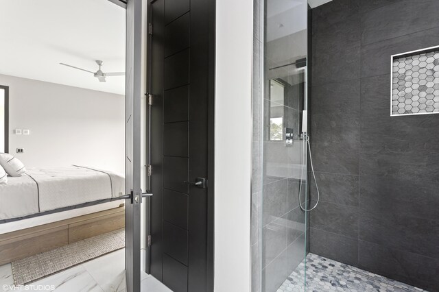 bathroom with a tile shower and ceiling fan