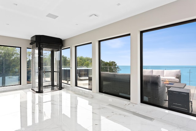 interior space with plenty of natural light and a water view