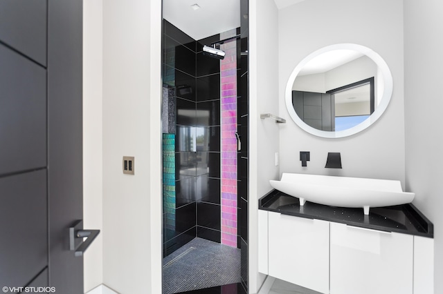 bathroom featuring vanity and a tile shower