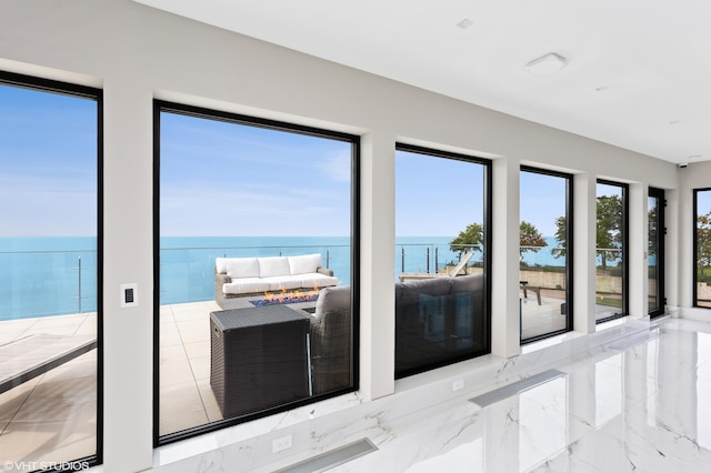 doorway featuring a water view and a wealth of natural light